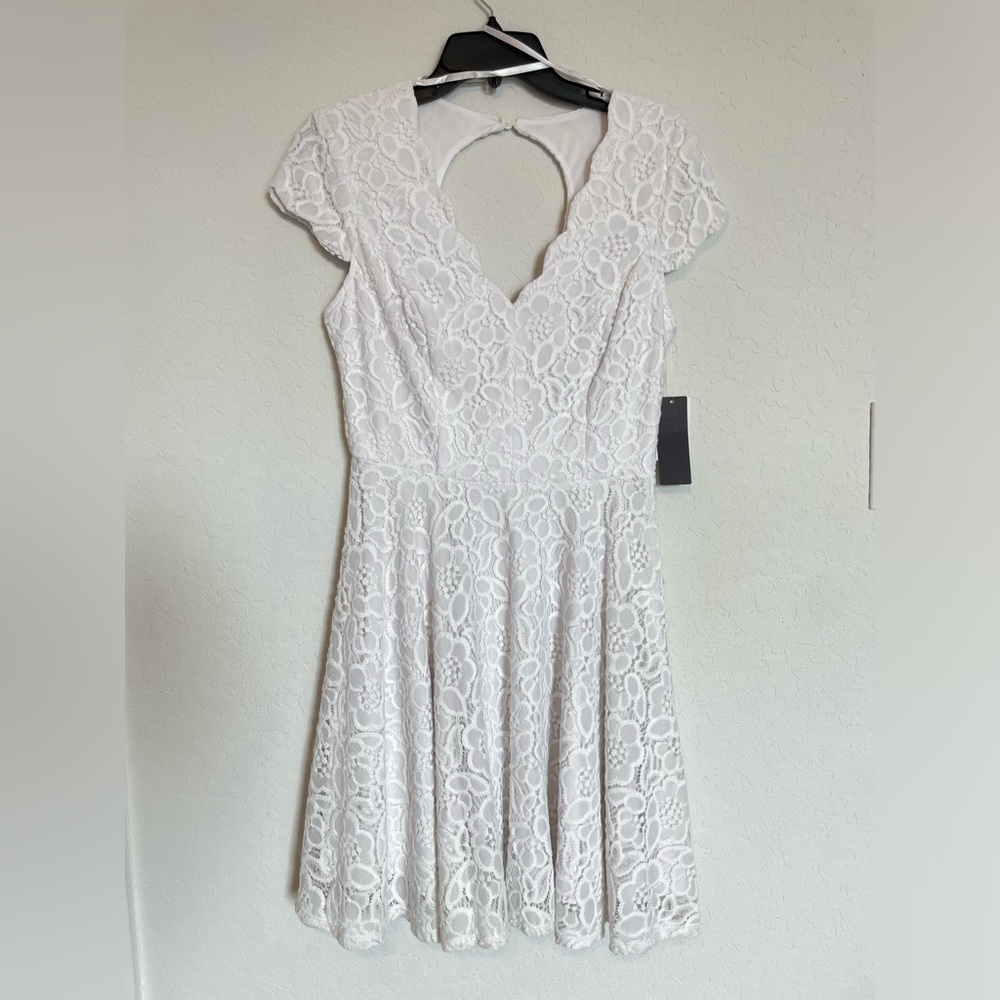 medium white dress perfect for any occasion. Very comfortable and brand new.
